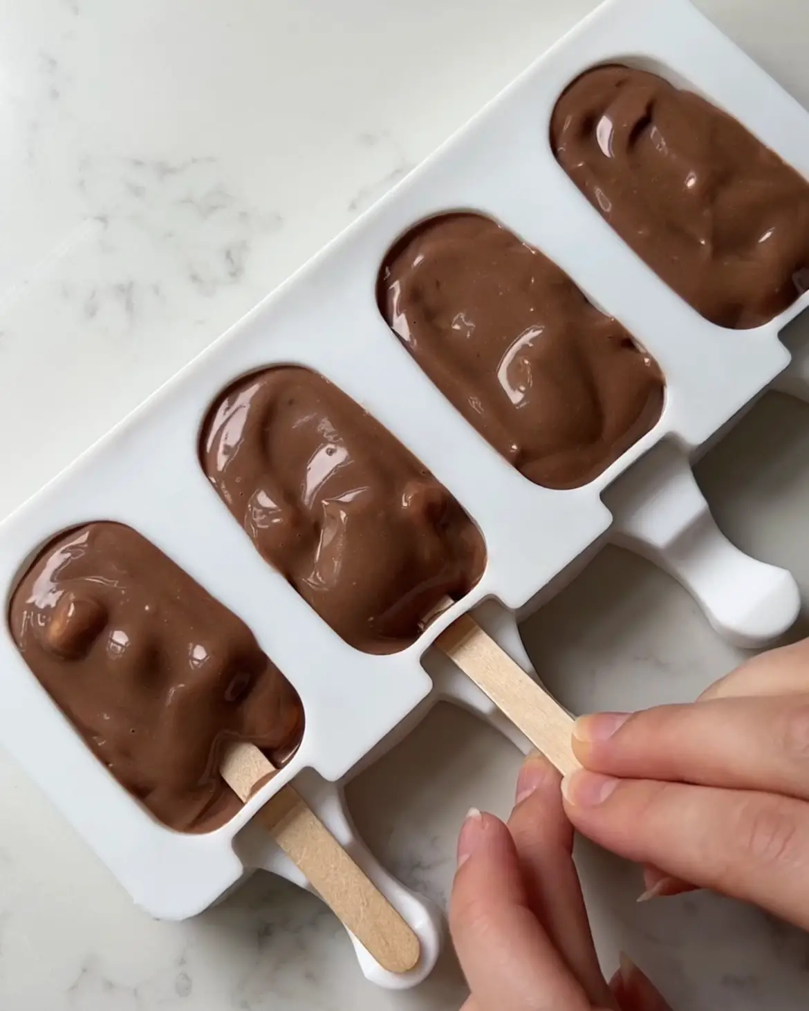 place the Chocolate Hazelnut Yoghurt Pops into moulds